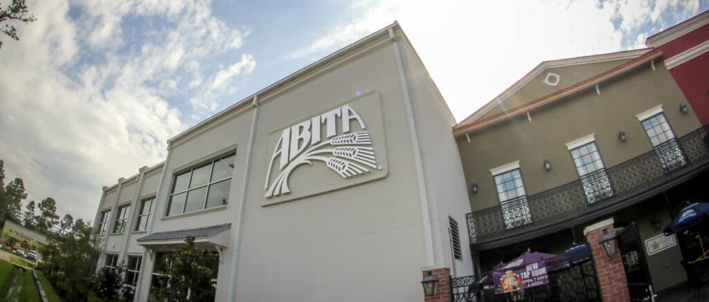 Abita Brewery building exterior with wheat-stalk logo signage and tap room banner