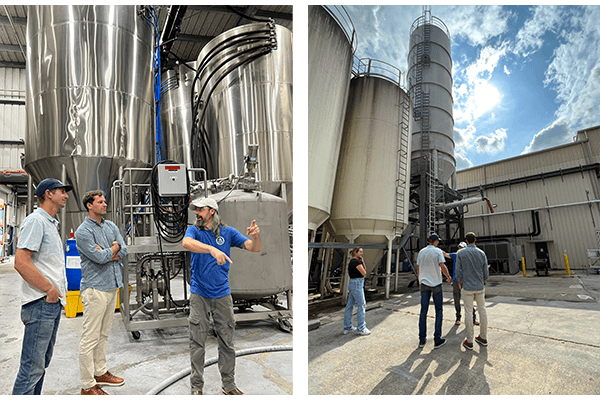Abita Brewery tour: staff beside fermentation tanks and exterior grain silos