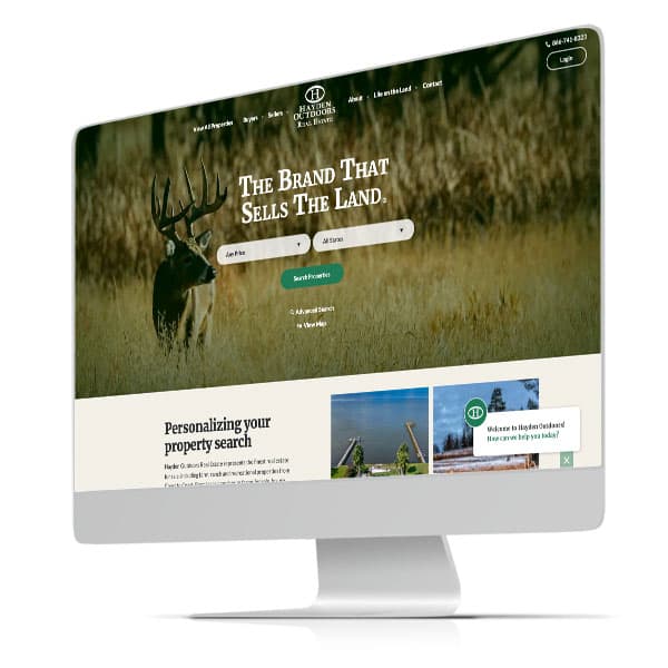 Hayden Outdoors Real Estate desktop homepage with property search over a photo of a deer in a field.