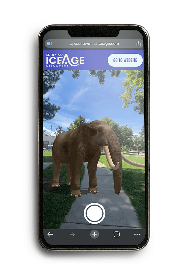 Snowmass Ice Age Discovery app screen showing an augmented reality mammoth on a sidewalk