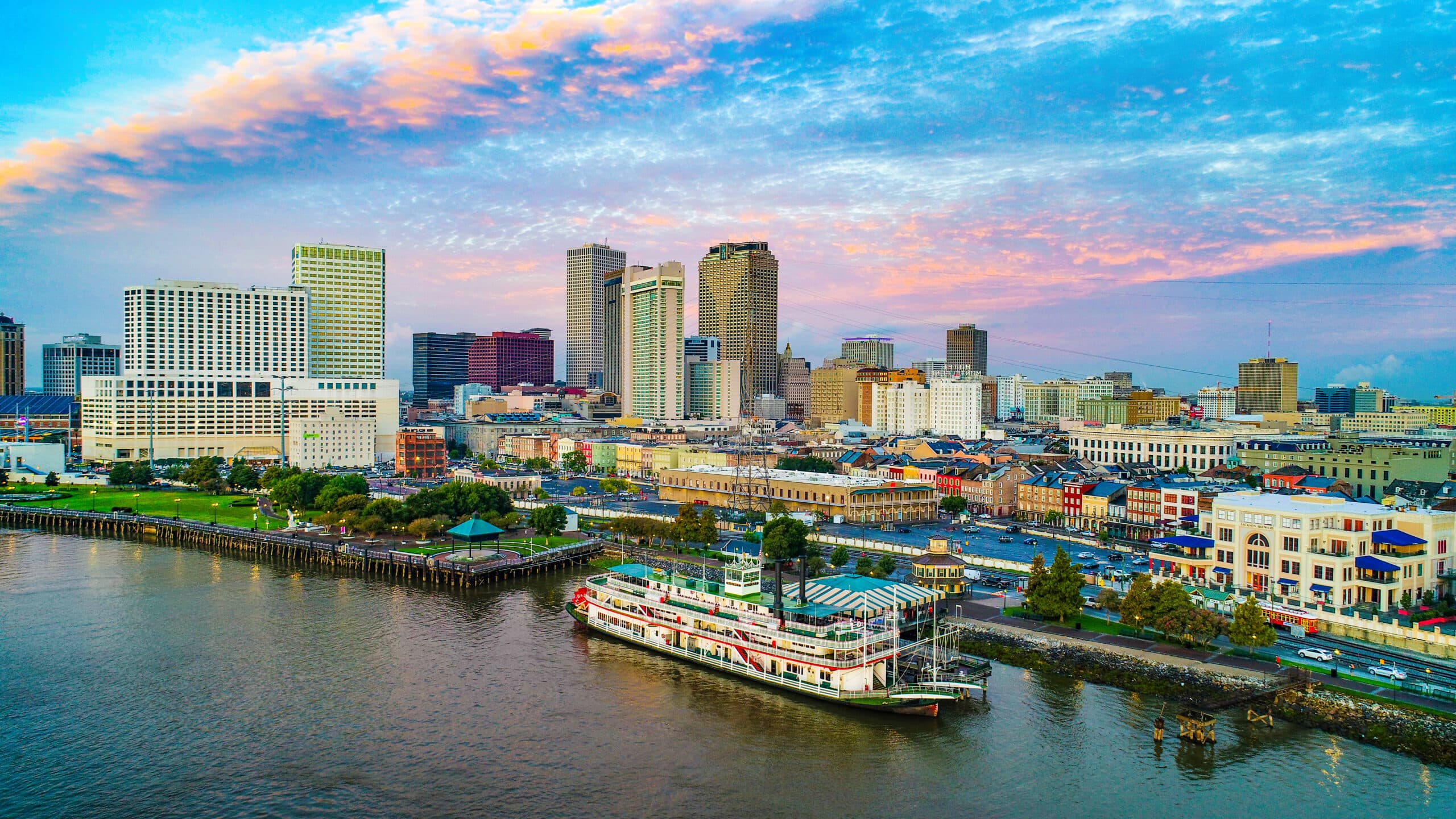 Aerial view of the New Orleans downtown skyline and riverfront at sunset