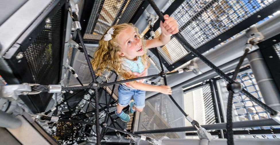 kid climbing on indoor structure