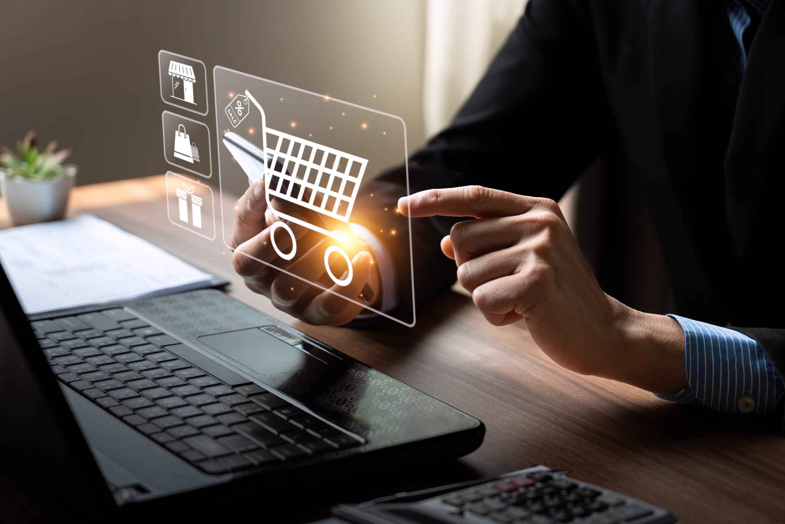 Businessman in a suit pointing at a holographic ecommerce shopping cart interface.