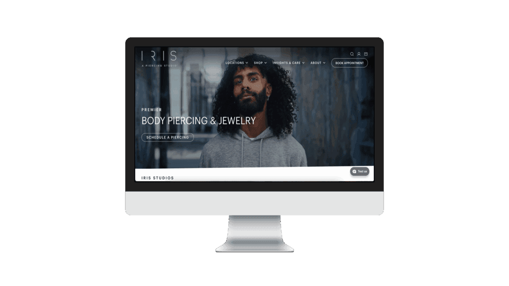 iMac mockup displaying the Iris Studios homepage with the headline Premier Body Piercing & Jewelry.