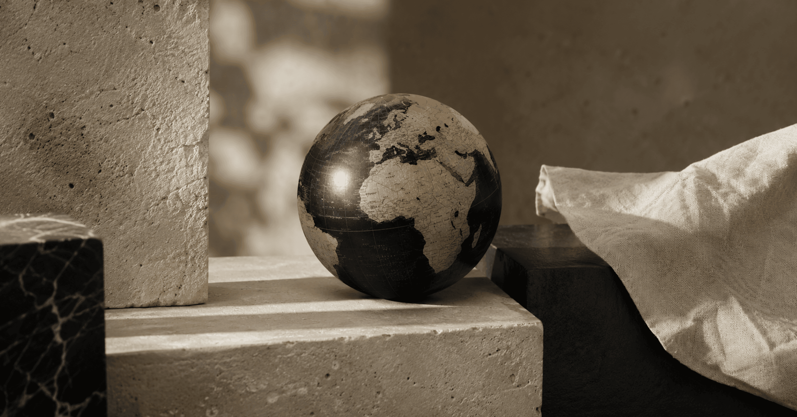A globe set amongst stone and fabric